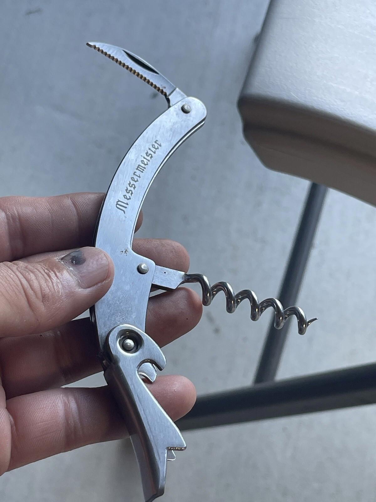 Multi purpose knife with corkscrew
