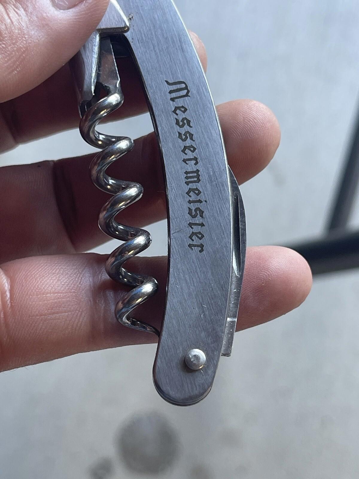 Multi purpose knife with corkscrew