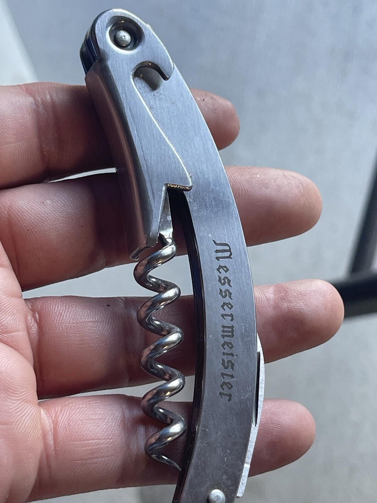 Multi purpose knife with corkscrew